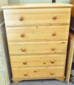 A pine chest of four long drawers