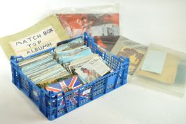 A collection of postcards and matchbox tops