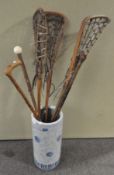 A stickstand with sticks and other items