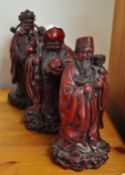 A set of three resin model buddhas