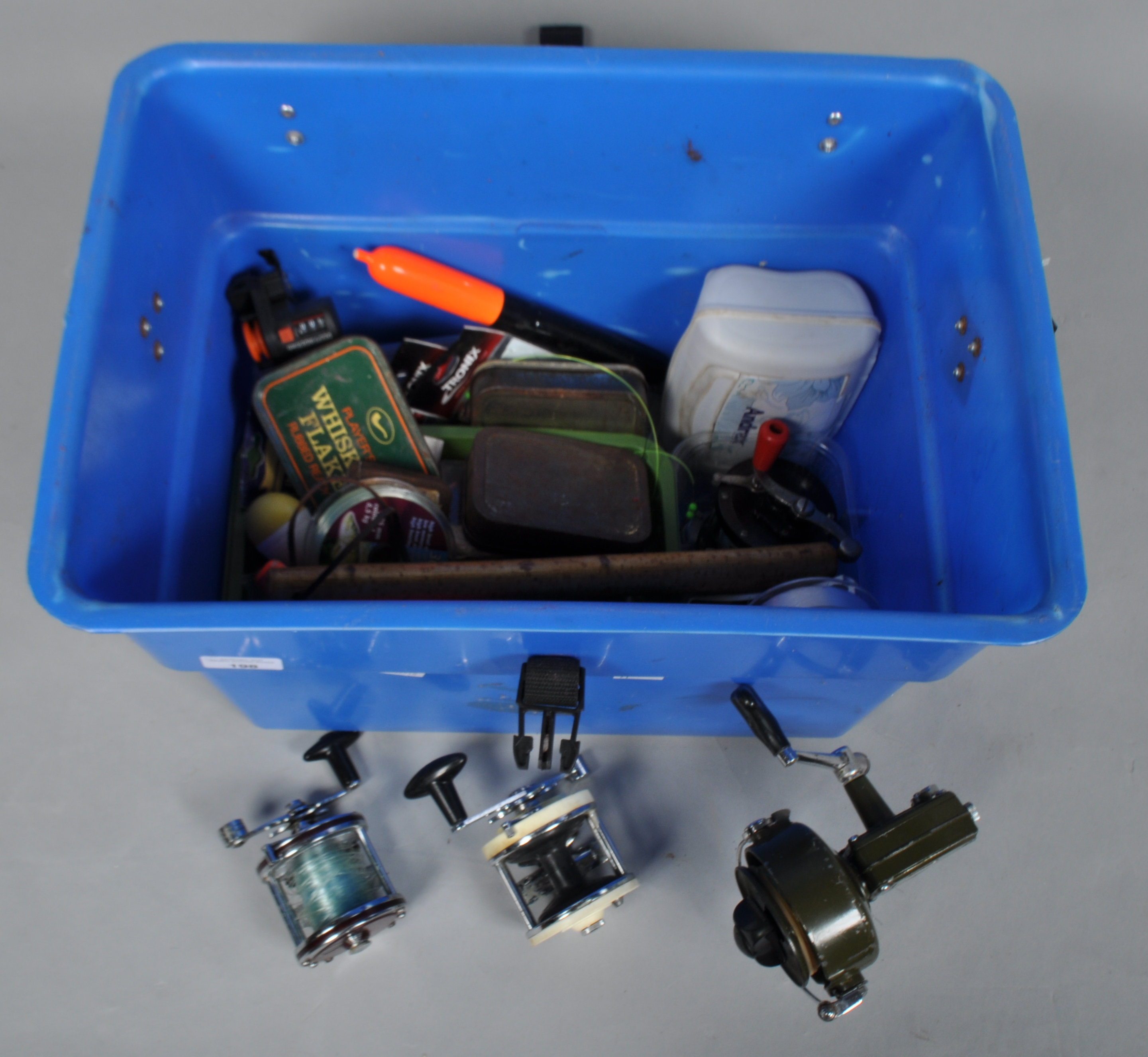 A seat box with a collection of sea reels and sea fishing tackle