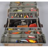 A cantilever tackle box with reels and approximately 50 plugs, spoons and other lures