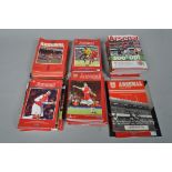 Two boxes of Arsenal football programmes and other memorabilia