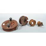 A box of four wooden centre pin fishing reels;