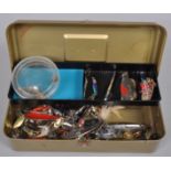 A metal tackle box containing heavy duty spoons,