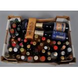 A collection of assorted of spirit and fortified wine miniatures and four bottles of commemorative