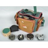 An Abu Garcia shoulder bag with a collection of fifteen trout fly reels and spare spools