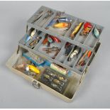A cantilver tackle box with assorted fishing lures