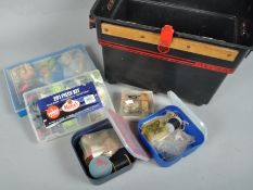 A tackle box with a quantity of plastic sea lures and other terminal tackle