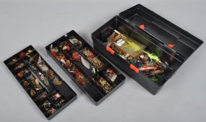 A tackle box with three trays of French and other European spinners and lures