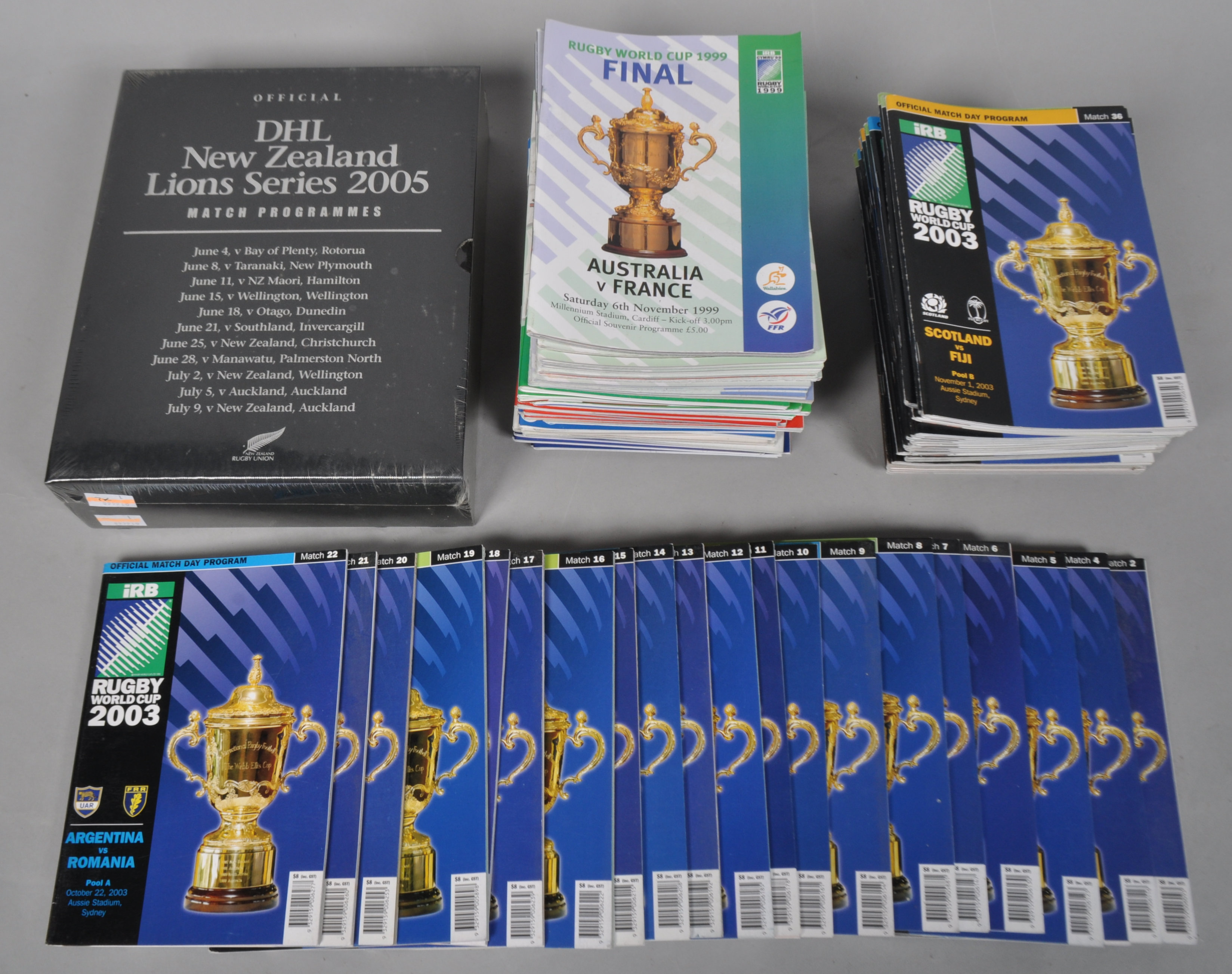 A collection of Rugby World Cup programmes and a sealed New Zealand Lions series match programme