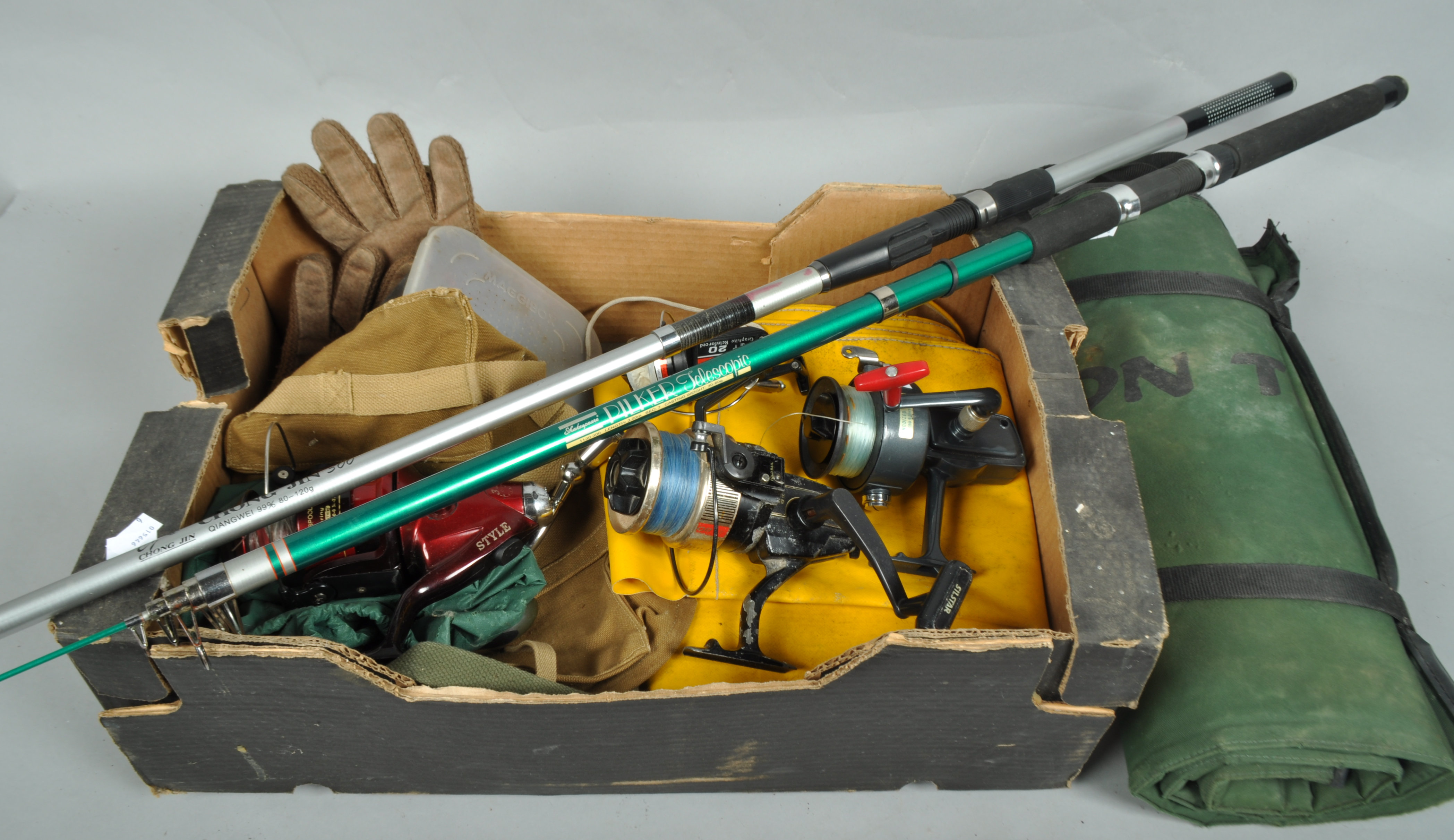 A box containing assorted beach casting fixed spool reels,