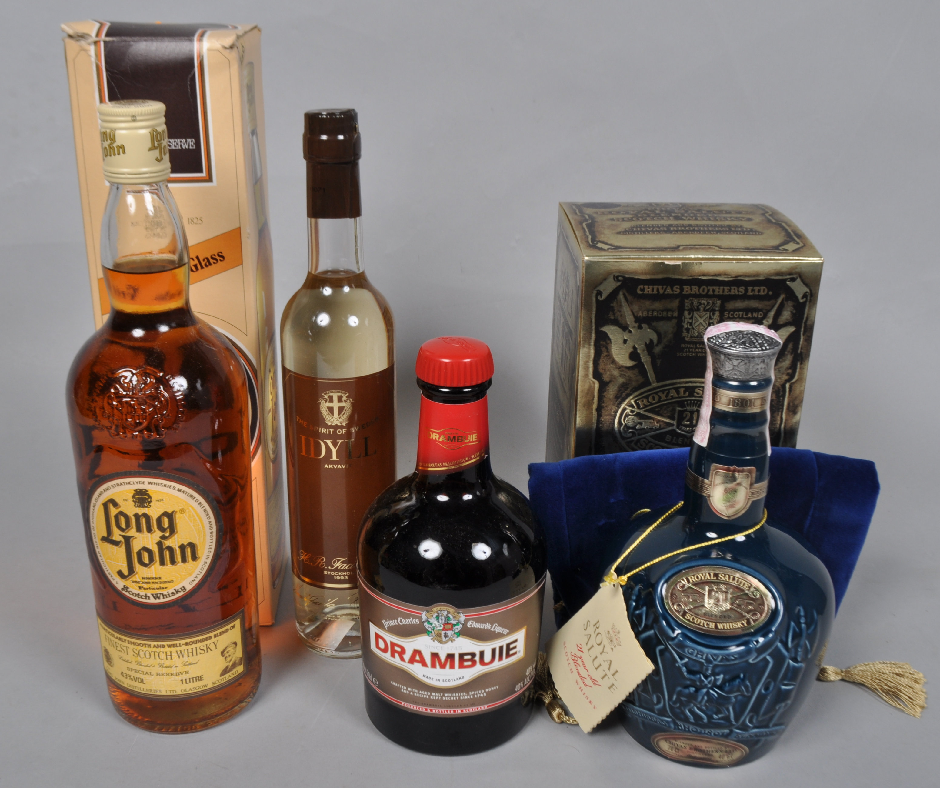 A flask Chivas Royal Salute, a bottle of Long John whisky and other bottles