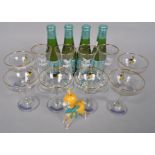 A collection of Babycham glasses together with four bottles and a plastic Babycham Bambi figure