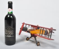 A novelty bottle of Denoix Cognac in the form of a bi-plane, 40% vol 350 ml, and a bottle of wine,