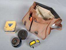 A shoulder bag containing a collection of trout fly reels and associated tackle