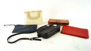 A Michasel Kors clutch bag together with other bags
