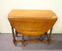 An oak drop leaf table on barley twist legs