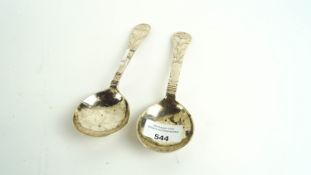 A pair of white metal spoons
