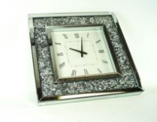 A wall clock with crystal set frame