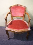 A reproduction French walnut carved elbow chair