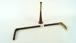 A copper and brass hunting horn and a hunting crop