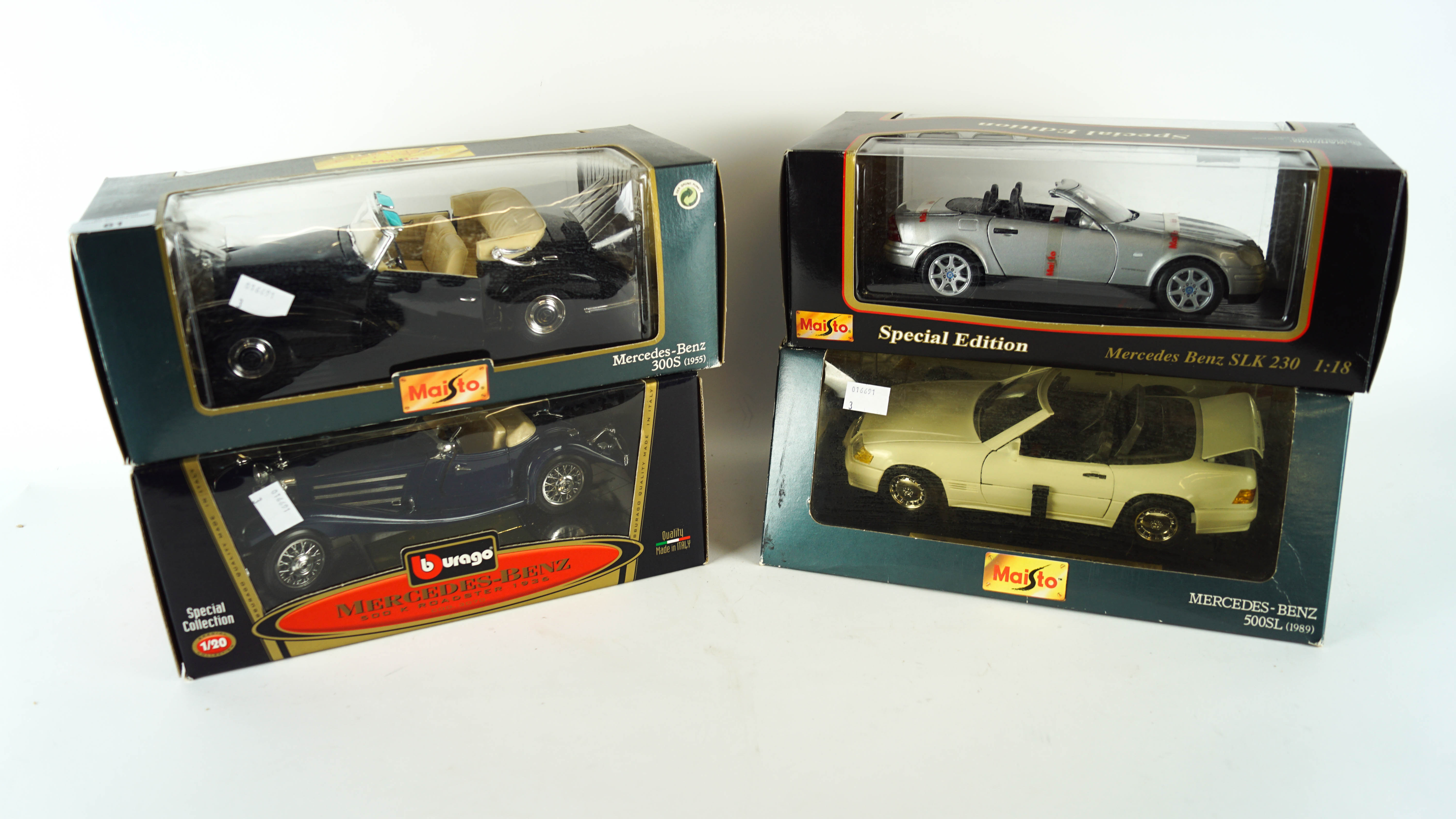 A collection of four 1:18 scale die cast model cars
