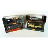 A collection of four 1:18 scale die cast model cars