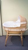 A 1960's wicker crib on stand