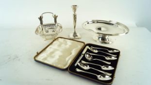 A silver candlestick and other silver plate