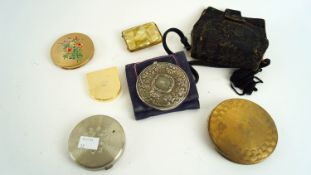 A group of compacts and a purse