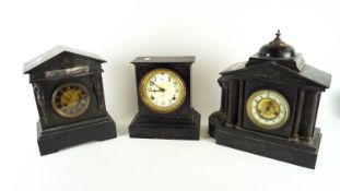 Two black slate mantel clocks and an iron one