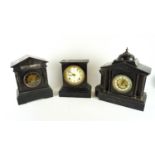 Two black slate mantel clocks and an iron one