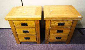 A pair of oak bedside tables