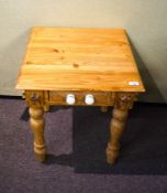 A pine side table with drawer set with two porcelain levers,