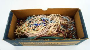 A box of beads and simulated pearls