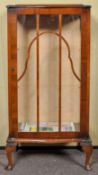 A 1930s mahogany glass display cabinet with astragal glazed door and raised on cabriole legs.