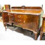 A mahogany serpentine fronted sideboard having gallery back,