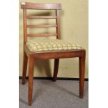 A 19th Century ladderback chair with upholstered seat.