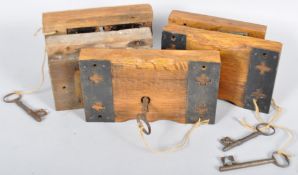 A collection of large Victorian gothic ecclesiastical lock and keys mounted to oak blocks.