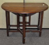 A mahogany oval drop leaf table