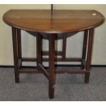 A mahogany oval drop leaf table