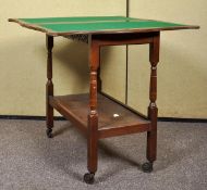 A 20th Century oak two tier trolley games table