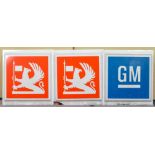 A pair of 1970's Vauxhall Griffin square light box signs with a GM sign
