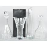 A Thomas Webb cut glass vase with original box along with two decanters and a carafe.