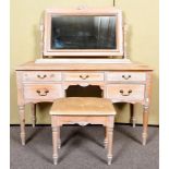 A limed and waxed pine dressing table and stool. Dressing table measures; 76cm x 123cm x 54cm.