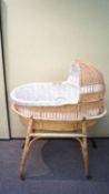 A 1960's retro vintage wicker weaved childs cradle on stand and castors.