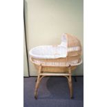 A 1960's retro vintage wicker weaved childs cradle on stand and castors.