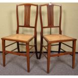 A pair of Edwardian inlay side chairs, with splat back over bergere cane work seats. Measures; 90cm.