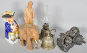 A Staffordshire Toby Jug along with figural carved wooden items and other items.